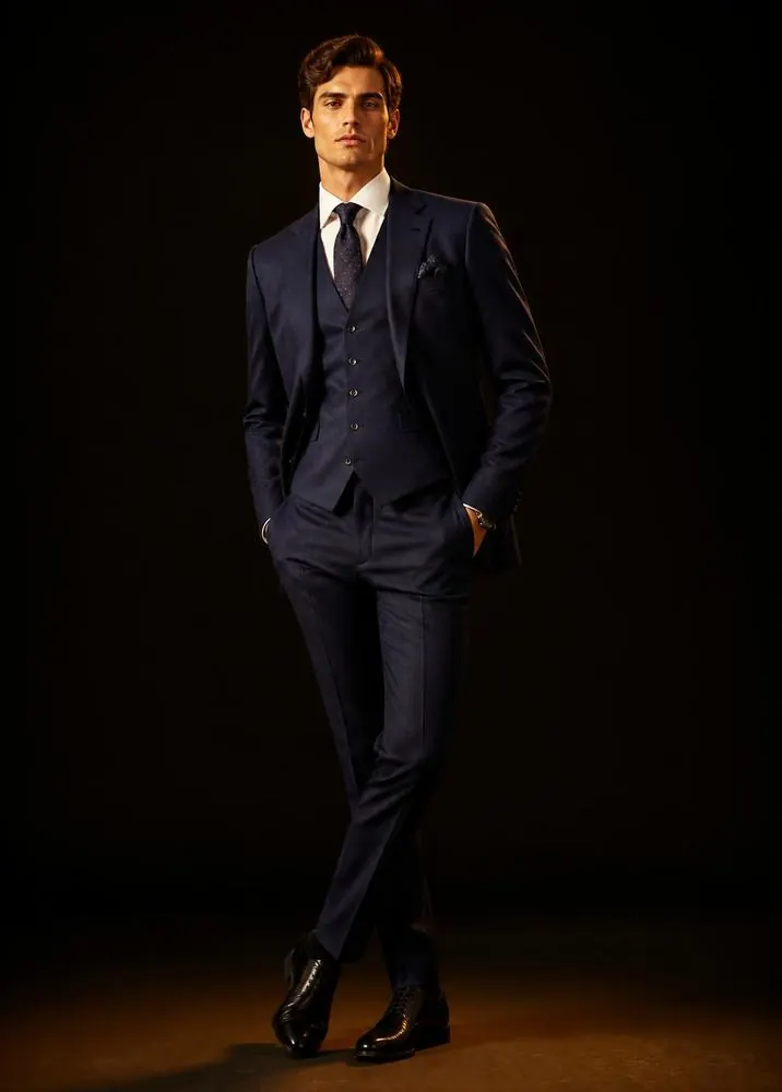 Model wearing a bespoke 3 piece suit for men with waistcoat, tailored in Karachi Pakistan